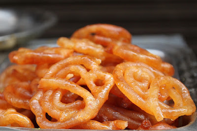 Crispy orange jalebi soaked in sugar syrup, a famous Indian street food dessert