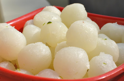 Soft white rasgullas soaked in light sugar syrup, a popular Indian dessert