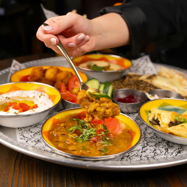 traditional Indian thali with dal, vegetables, chutney and home cooked Indian food served on a metal plate
