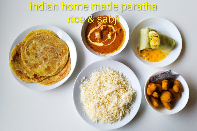 Indian homemade paratha with rice and sabji served as a simple home cooked Indian meal